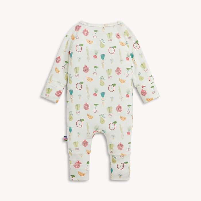 A baby long-sleeve footless one-piece romper in white, featuring an all-over colorful print of illustrated fruits and vegetables, shown against a light gray background.
