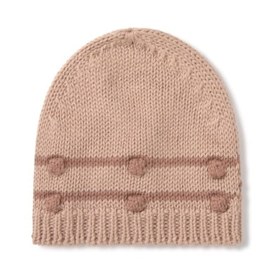 Knitted beanie with pom-poms on a white background