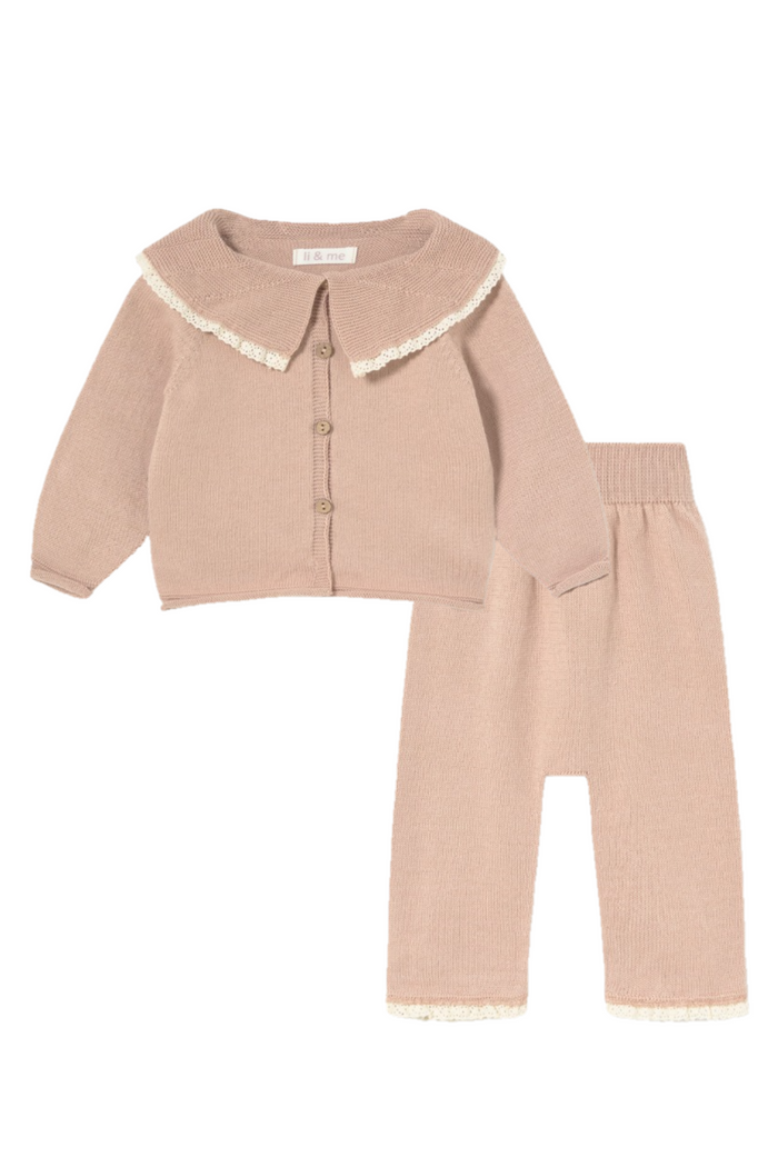 Pink children's outfit with lace details on a white background
