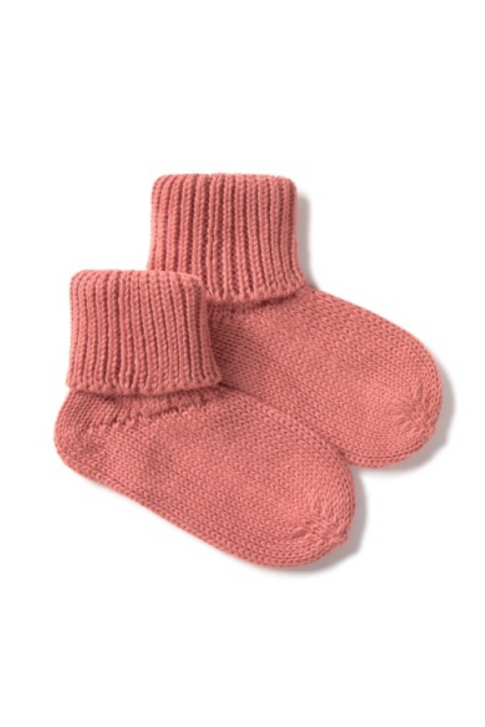 Pair of pink knitted socks on a white background