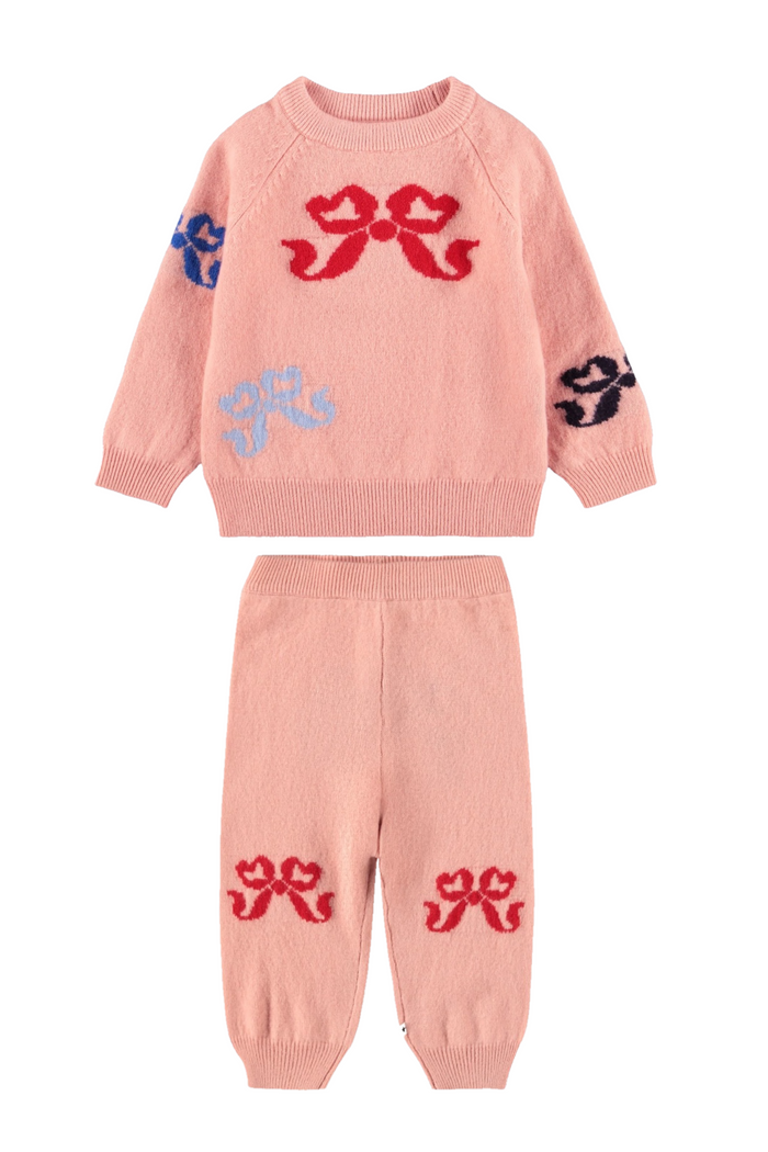Pink children's sweater and pants set with bow designs on a white background