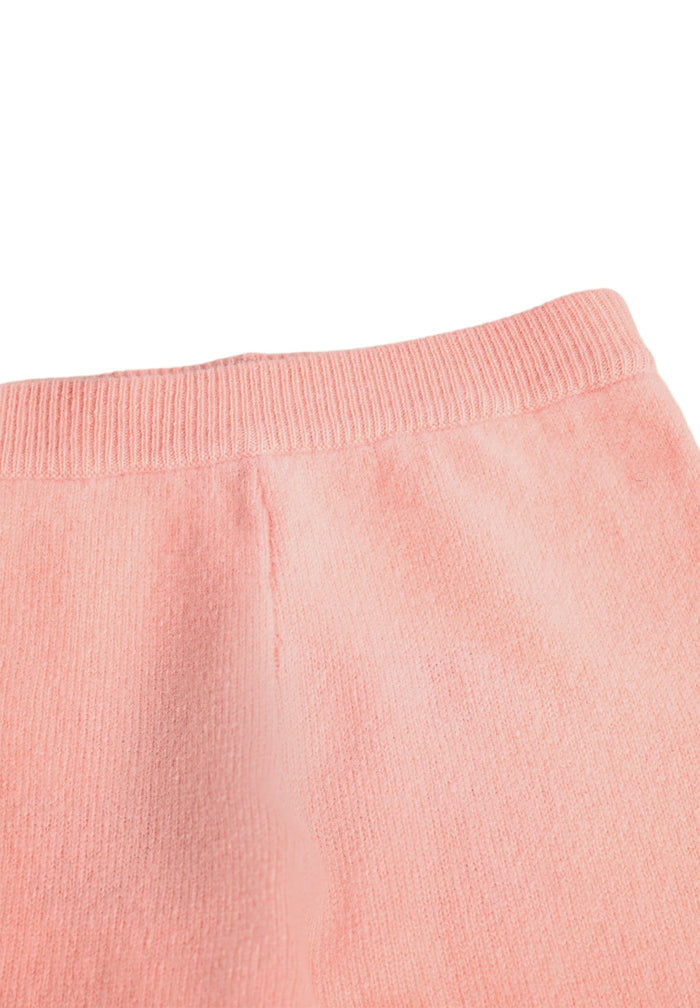 Close-up of pink sweatpants on a white background
