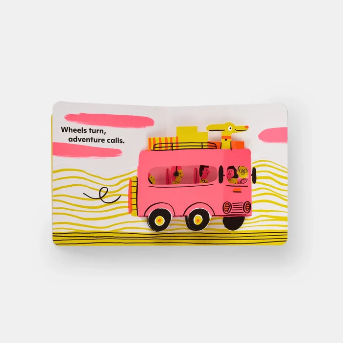 Children's book with a pink bus and dog illustration on a white background